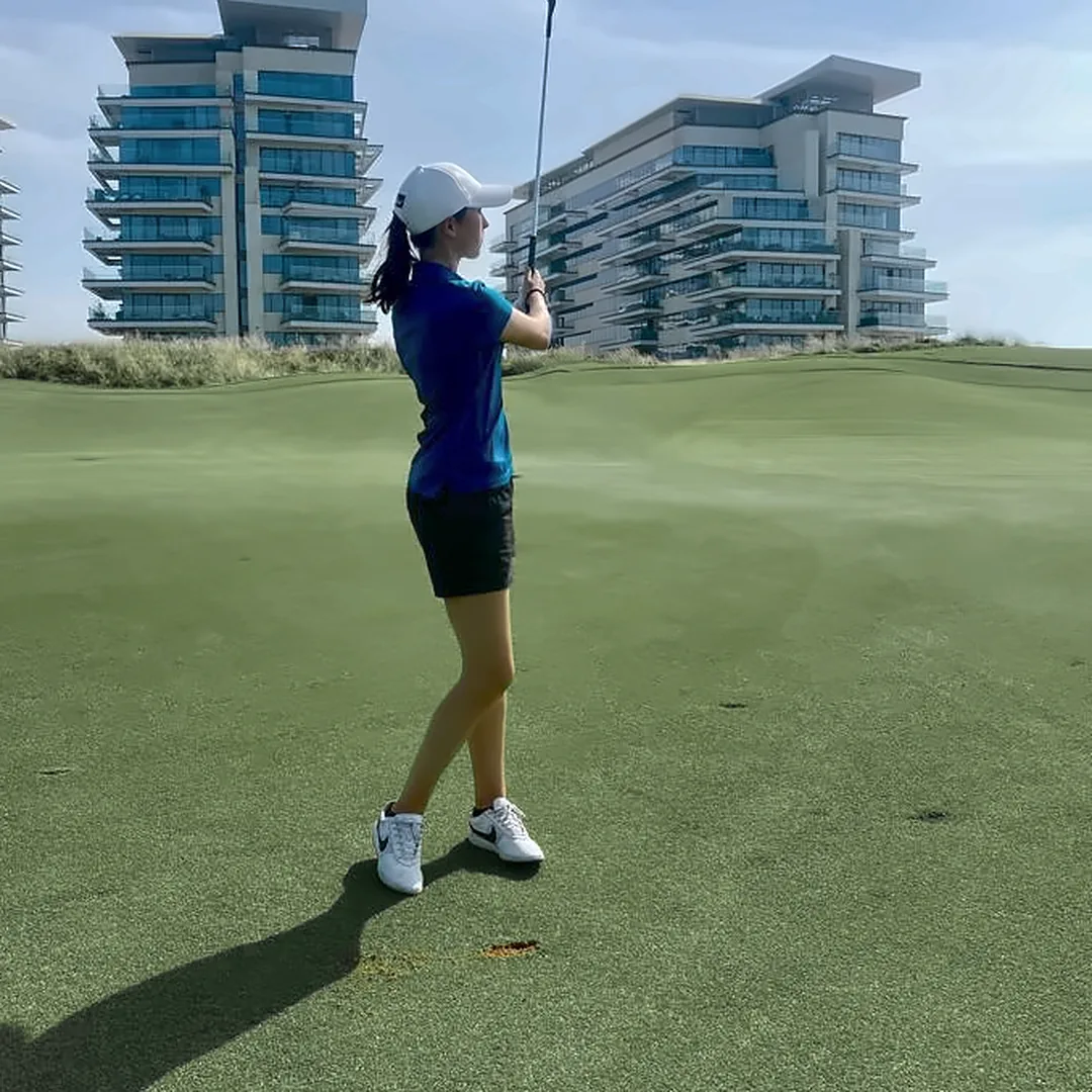 Lili Brecken playing a shot on the course